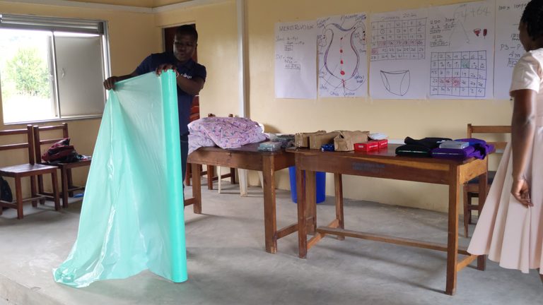 Trainer displaying fabric during a practical menstrual care workshop