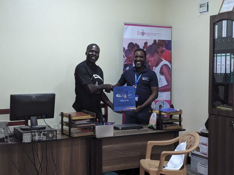 Esonga team receiving materials during a meeting with a partner organisation