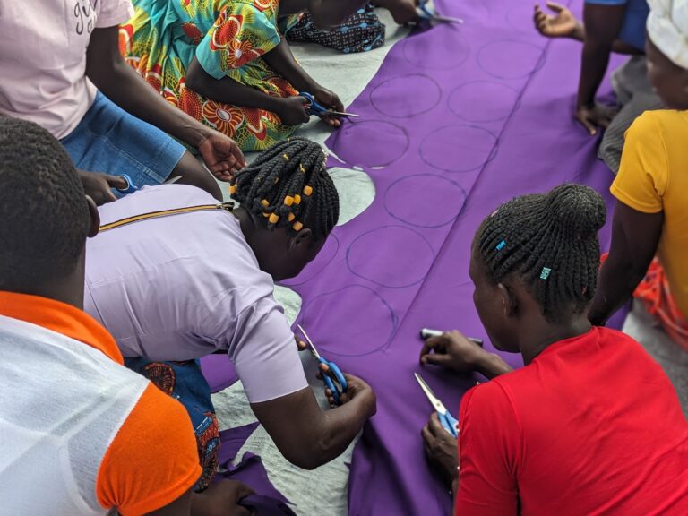 Esonga Menstrual Care community training with participants making reusable pads